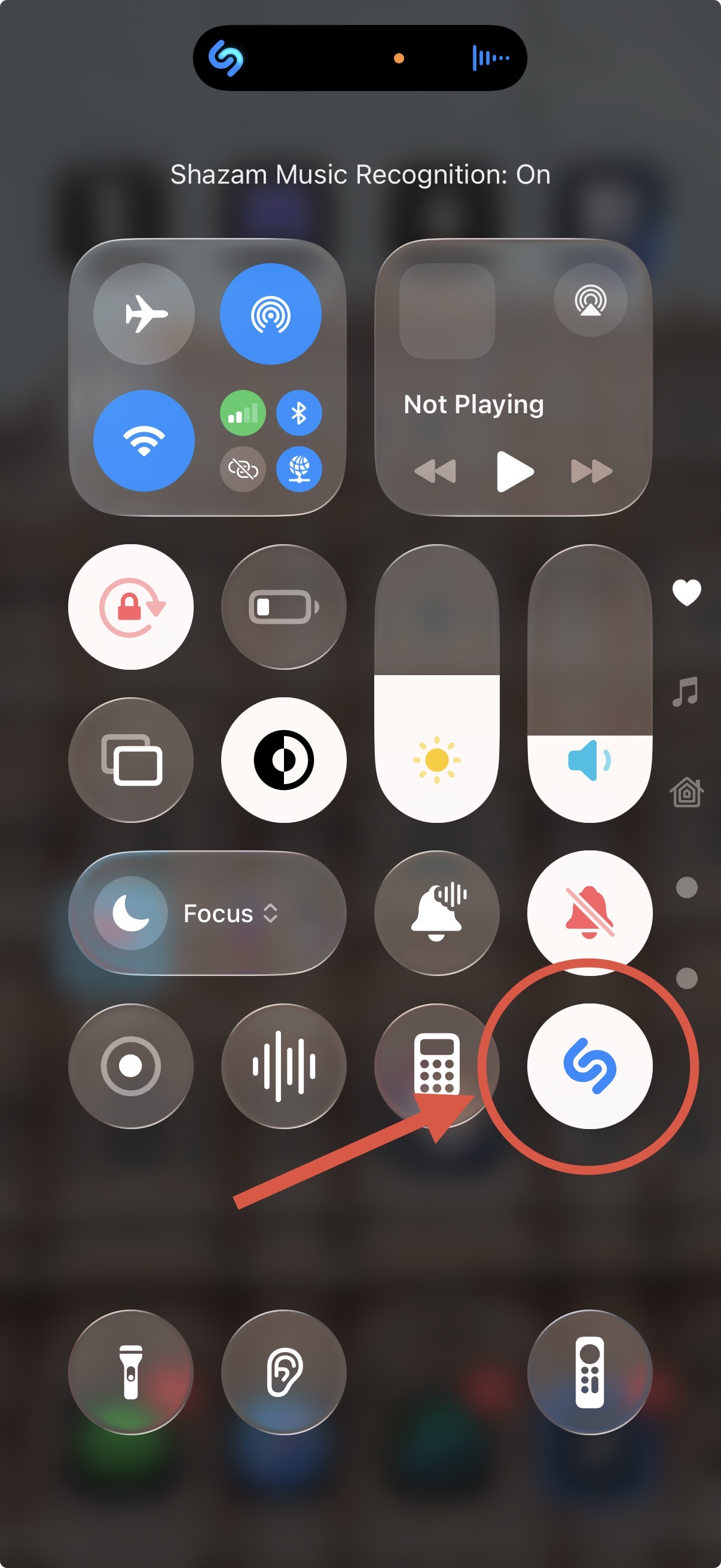 Screenshot of iOS Control Center showing the Recognize Music (Shazam) button highlighted while an app is active in the background